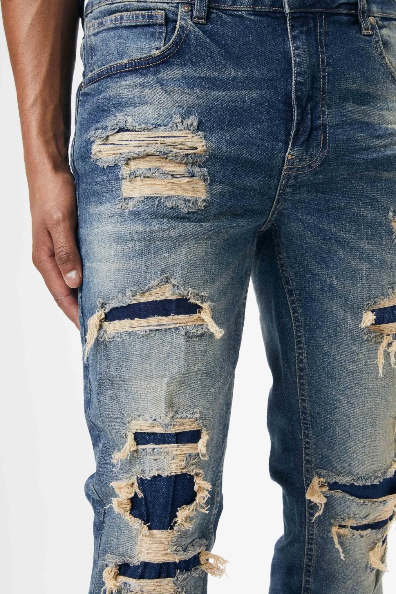Ripped and Repaired Denim Jeans in Tint Blue